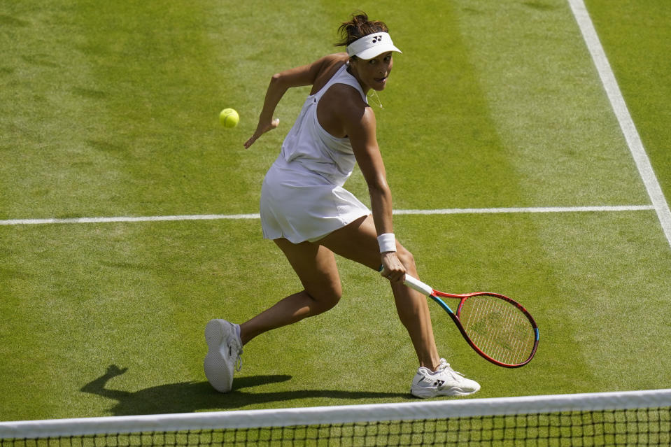 Germany's Tatjana Maria returns to Tunisia's Ons Jabeur in a women's singles semifinal match on day eleven of the Wimbledon tennis championships in London, Thursday, July 7, 2022. (AP Photo/Gerald Herbert)