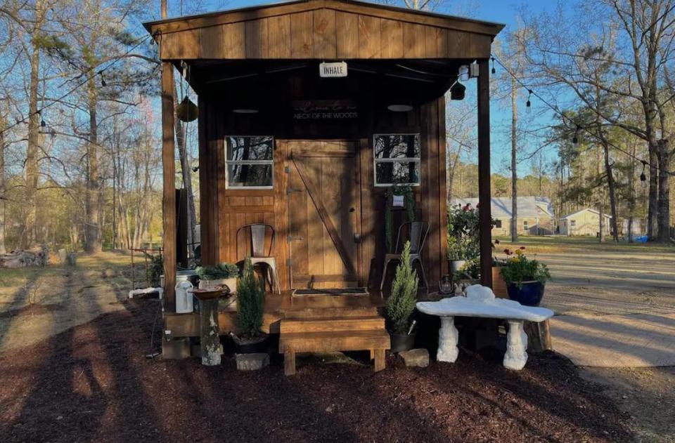 This tiny home cabin in Conway sits next to a pond and offers a camper’s retreat.