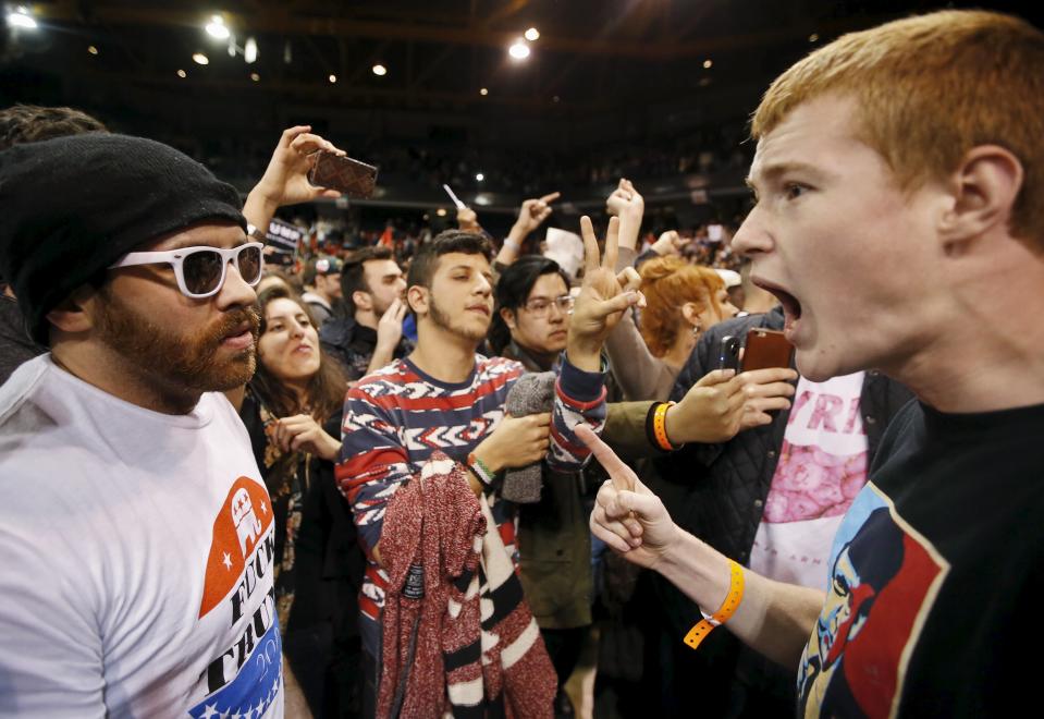 A Trump supporter (R) yells at a demonstrator (L) after Republican U.S. presidential candidate Donald Trump cancelled his rally at the University of Illinois at Chicago March 11, 2016. (REUTERS/Kamil Krzaczynski)