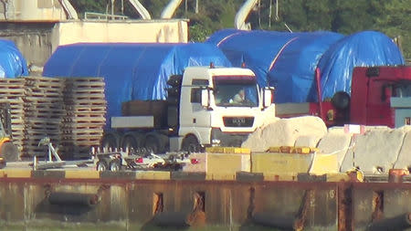 A still image taken from a video footage shows blue tarpaulins covering equipment at the port of Feodosia, Crimea July 11, 2017. Video footage taken July 11, 2017. REUTERS/Staff