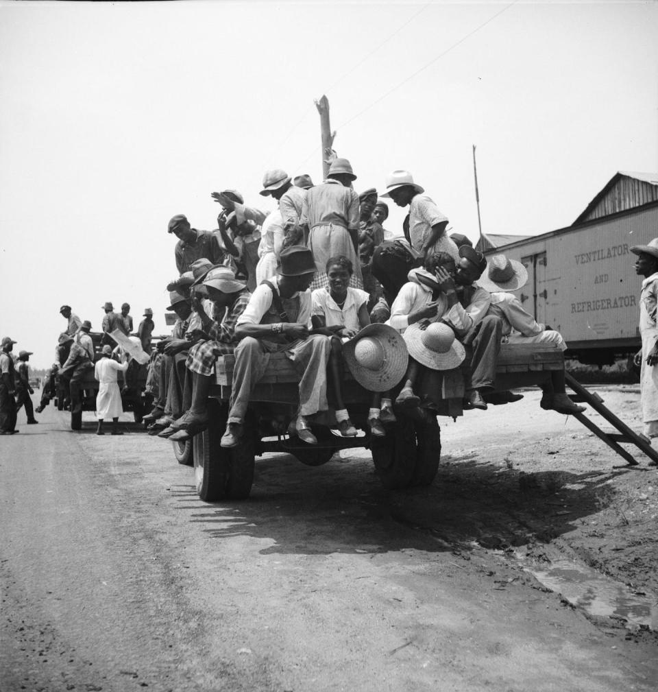 Peach pickers being driven to the orchards in Muscella, Ga., in 1936. The workers earned 75 cents per day. <a href="https://www.gettyimages.com/detail/news-photo/peach-pickers-being-driven-to-the-orchards-they-earn-news-photo/1400608997" rel="nofollow noopener" target="_blank" data-ylk="slk:Dorothea Lange, Heritage Art/Heritage Images via Getty Images;elm:context_link;itc:0;sec:content-canvas" class="link ">Dorothea Lange, Heritage Art/Heritage Images via Getty Images</a>