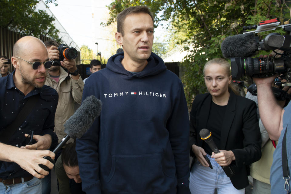 Russian opposition leader Alexei Navalny speaks to the media as he leaves a detention center after he was released, in Moscow, Russia, Friday, Aug. 23, 2019. Navalny, the Kremlin's most prominent foe, was sentenced last month to 30 days for calling on people to take part in an unauthorized protest. (AP Photo/Dmitry Serebryakov)