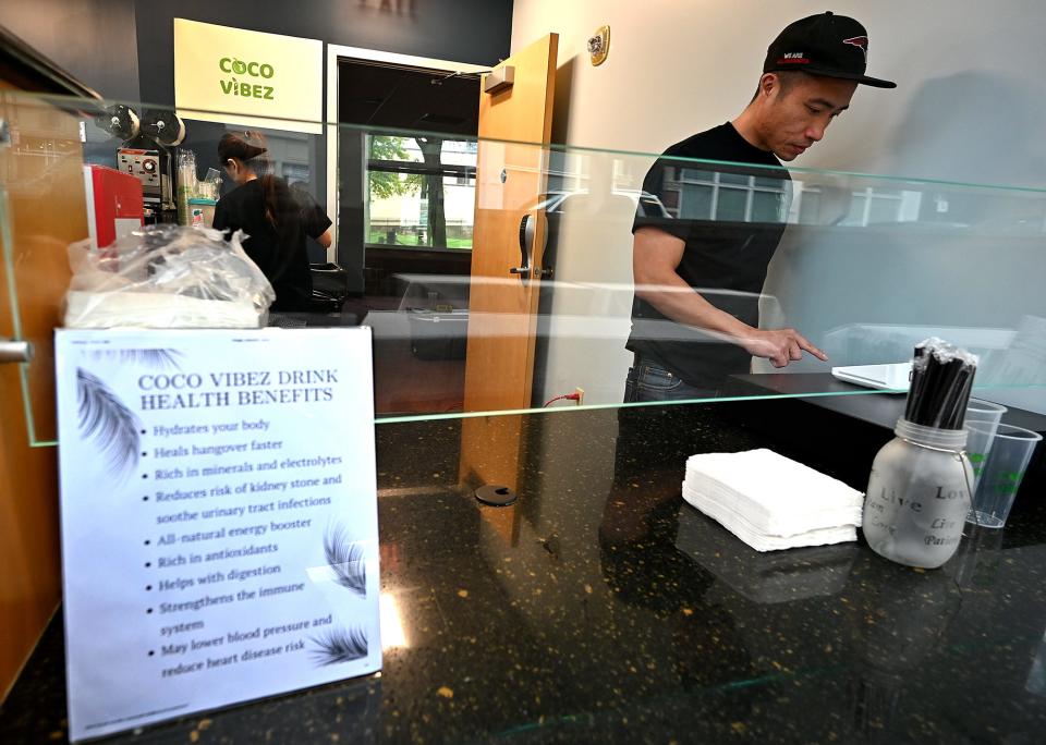 Phi Le of Worcester works behind the counter at Coco Vibez at the new Worcester Regional Food Hub location at the corner of Main and Pleasant streets in Worcester.