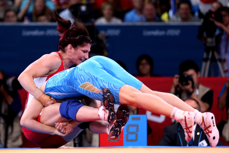 LONDON, ENGLAND - AUGUST 09: Saori Yoshida of Japan (blue) and Tonya Lynn Verbeek of Canada compete in the Women's Freestyle 55 kg Wrestling on Day 13 of the London 2012 Olympic Games at ExCeL on August 9, 2012 in London, England. (Photo by Quinn Rooney/Getty Images)