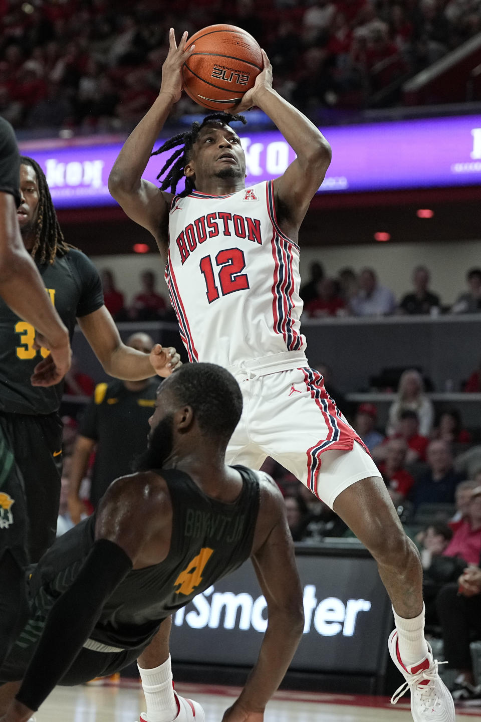 Houston guard Tramon Mark (12) draws a block from Norfolk State guard Joe Bryant Jr. (4) during the first half of an NCAA college basketball game, Tuesday, Nov. 29, 2022, in Houston. (AP Photo/Kevin M. Cox)