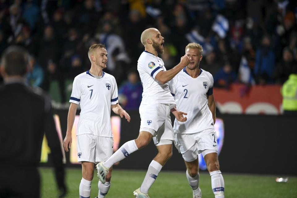 Teemu Pukki of Finland, center, celebrates his goal with teammates Jasse Tuominen, left, and Paulus Arajuuri during the Euro 2020 Group J qualifying soccer match between Finland and Liechtenstein in Helsinki, Finland, on Friday, Nov. 15, 2019. (Martti Kainuleinen/Lehtikuva via AP)