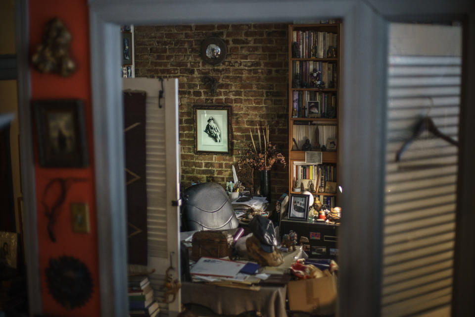 A chair sits empty under a portrait of Walt Whitman at the desk of Arnie Kantrowitz in his New York apartment, Thursday, March 17, 2022. When the omicron variant swept through New York last winter, Kantrowitz got sick. At first, it seemed like a cold and a fever, but then the coronavirus infection derailed his diabetes. Author, Walt Whitman scholar and gay rights activist, Kantrowitz died Jan. 21, 2022, at age 81. "I don't want to be one of these people who walks around talking to the dead," says his longtime partner, Larry Mass, but he does ask Arnie's advice, even now, when world events unleash in him an anger that feels unmanageable and damaging, an anger that's just looking for a place to land. He will think about what Arnie would have said to bring him back to earth. He was always good at that. "He's not totally gone," Mass says. "He's there in my heart." (AP Photo/David Goldman)