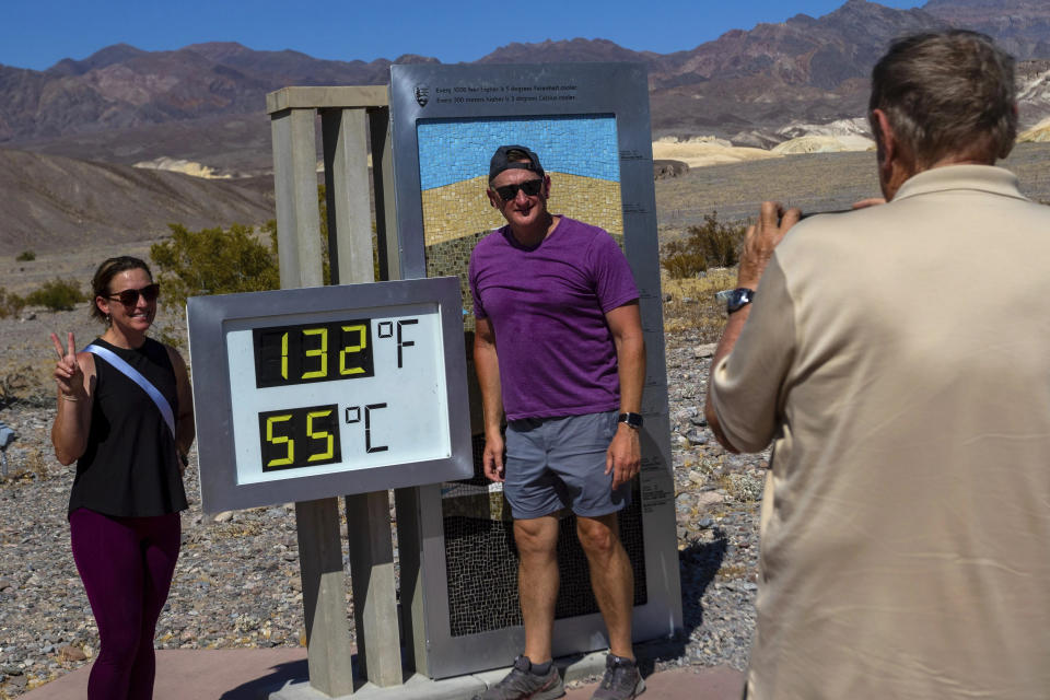 Tourists pose beside a temperature display in Death Valley National Park (AP)