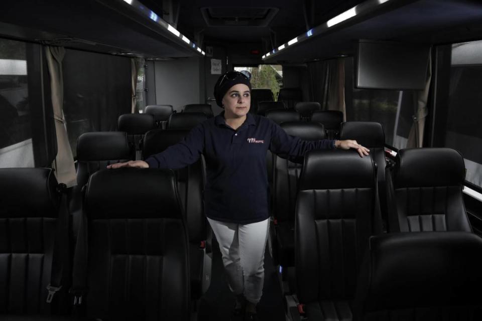 Sanaa Ghorab, owner of VIP Shuttle, stands inside one of her empty buses on June 11, 2020. Normally used to transport cruise passengers to and from PortMiami, the buses have been parked at an empty lot in Brownsville since the COVID-19 pandemic shut down the cruise industry in mid-March.