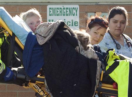 Members of a family that went missing are wheeled by stretcher from an ambulance into the Pershing General Hospital in Lovelock, Nevada, December 10, 2013. REUTERS/James Glover