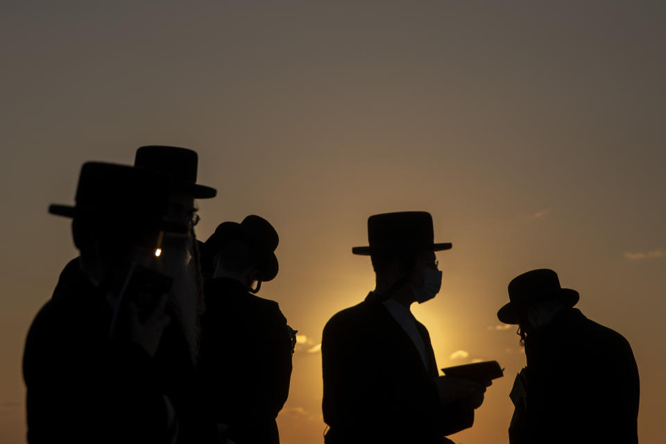 Ultra-Orthodox Jews of the Kiryat Sanz Hassidic sect pray on a hill overlooking the Mediterranean Sea as they participate in a Tashlich ceremony during a nationwide three-week lockdown to curb the spread of the coronavirus in Netanya, Israel, Thursday, Sept. 24, 2020. Israel moved to further tighten its second countrywide lockdown as coronavirus cases continued to soar. (AP Photo/Ariel Schalit)