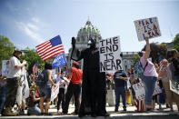 Protesters demonstrate during a rally against Pennsylvania's coronavirus stay-at-home order at the state Capitol in Harrisburg, Pa., Friday, May 15, 2020. (AP Photo/Matt Rourke)