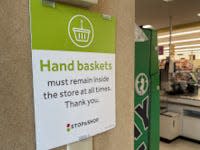 Some customers are not paying attention to signs like this one at Stop & Shop in Middletown. Grocers report that people are taking baskets out of the store and not bringing them back.