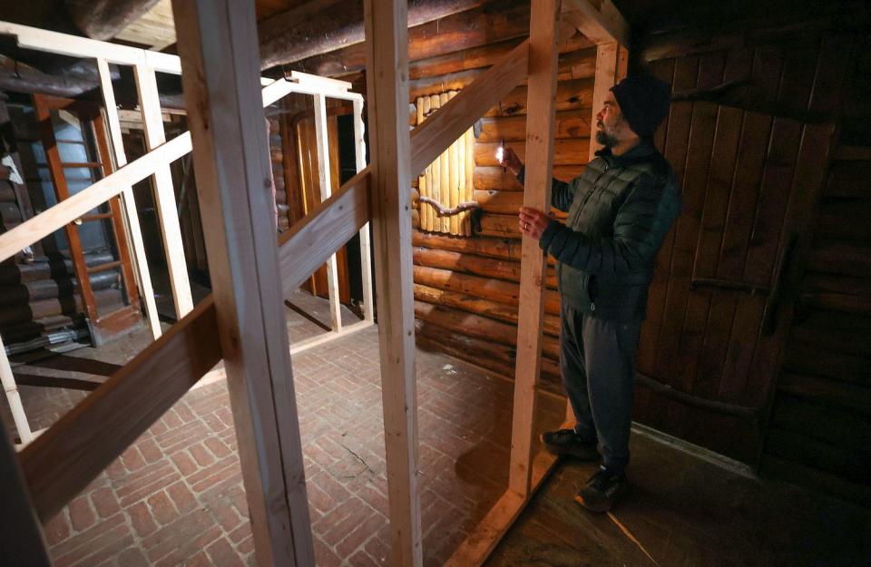 Patrick DePaulis, Friends of Allen Park vice chairman, shows two-by-fours that have been installed to help support the structure of Allen Lodge at Allen Park in Salt Lake City on Tuesday. Work is underway to replace the historic building’s roof.