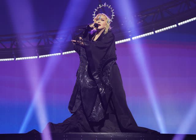 <p>Kevin Mazur/WireImage</p> Madonna performs in London on Oct. 14, 2023