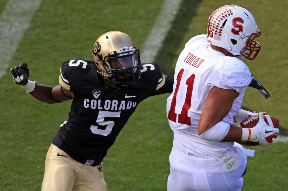 Tight end Levine Toilolo #11 of the Stanford Cardinals makes a 19 yard touchdown reception against defensive back Yuri Wright #5 of the Colorado Buffaloes in the third quarter at Folsom Field on November 3, 2012 in Boulder, Colorado. The Cardinal defeated the Buffaloes 48-0. (Photo by Doug Pensinger/Getty Images)