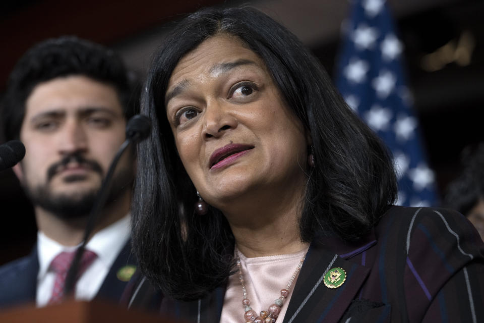 Representative Pramila Jayapal at the microphone, with Representative Greg Casar on her right.