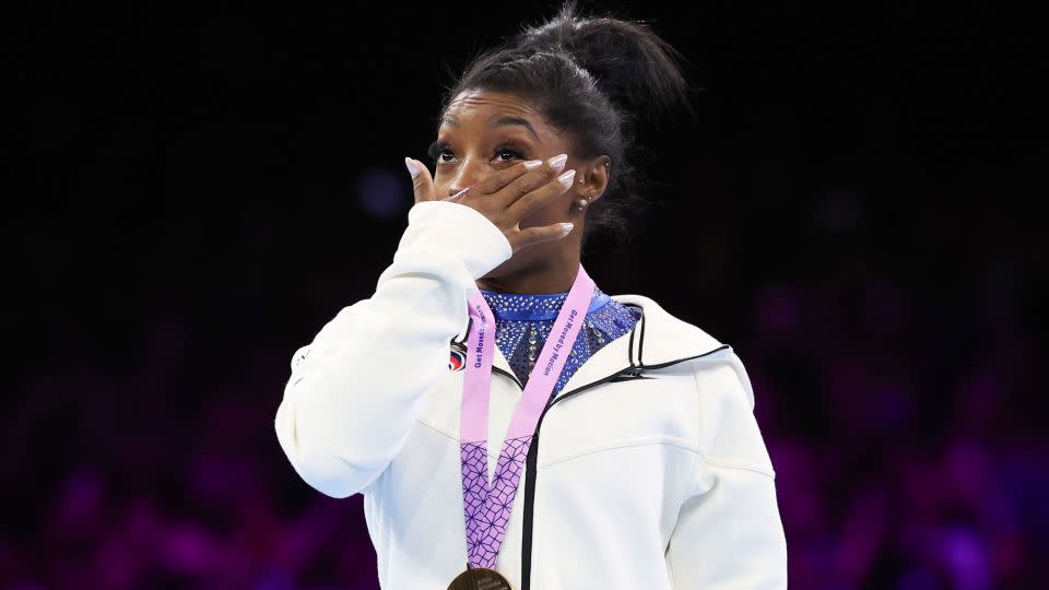 Biles cries on the podium after wining the gold medal at the women's all-round final. - Geert vanden Wijngaert/AP