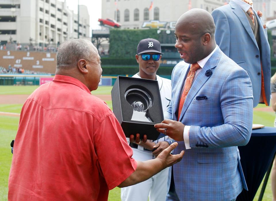 Former Detroit Tigers player Willie Horton, left, presents another former Tiger, Craig Monroe, with the Detroit Tigers Willie Horton African American Legacy Award as Tigers first base coach Ramon Santiago, center, looks on before a game against the Kansas City Royals, Sunday, Aug. 11, 2019, in Detroit.