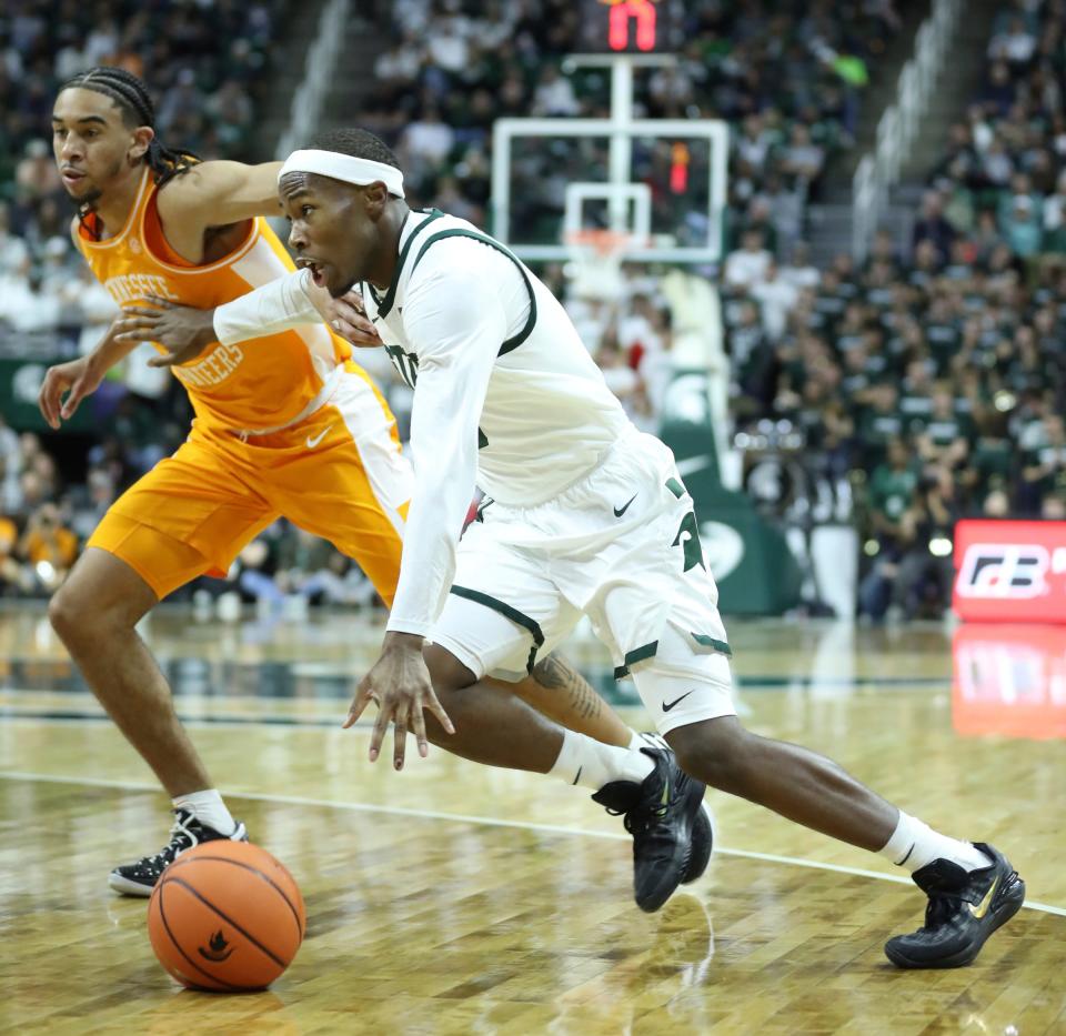 Michigan State Spartans guard Tre Holloman (5) drives against Tennessee Volunteers guard Freddie Dilione V (1) during second-half action at Breslin Center in East Lansing on Sunday, Oct. 29, 2023.