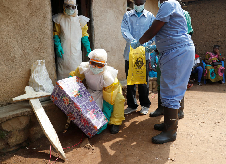 A healthcare worker holds a coffin for a baby suspected of dying of Ebola during the funeral in Beni, North Kivu Province of Democratic Republic of Congo, December 18, 2018.  