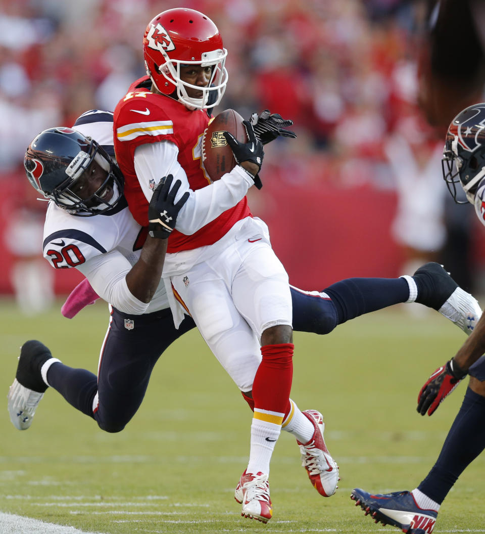 FILE - In this Oct. 20, 2013, file photo, Kansas City Chiefs wide receiver Donnie Avery (17) is tackled by Houston Texans free safety Ed Reed (20) during the first half of an NFL football game at Arrowhead Stadium in Kansas City, Mo. Towering tight end Tony Gonzalez is heading to the Hall of Fame, to be joined by three defensive backs who spent parts of their career trying to stop him. Champ Bailey, Reed and Ty Law were also voted into the Hall on Saturday, Feb. 2, 2019. (AP Photo/Ed Zurga, File)