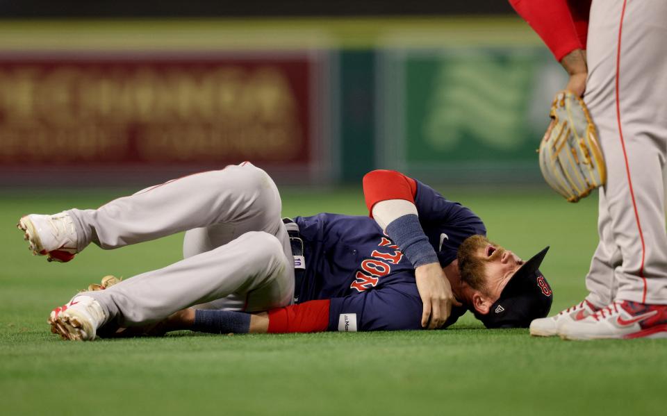 Red Sox shortstop Trevor Story grabs his shoulder in pain after injuring it on a play during a game last week in Anaheim.