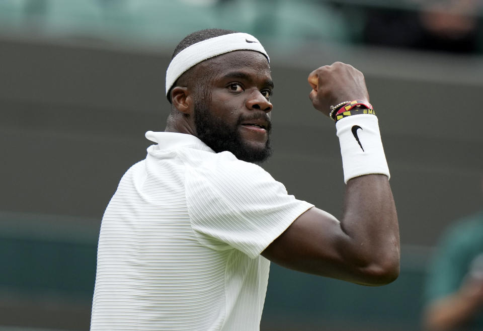 Frances Tiafoe of the US celebrates after breaking the serve of Stefanos Tsitsipas of Greece during the men's singles match on day one of the Wimbledon Tennis Championships in London, Monday June 28, 2021. (AP Photo/Alastair Grant)