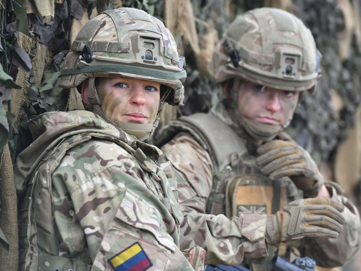 Royal Army Medical Cops medic Corporal Vicky Helsby (left), 29, from Runcorn, Royal Wessex Yeomanry Tank Gunner reservist Lance Corporal Cat Dixon, 28, from Swindon and Royal Army Veterinary Corps Dog Handler Private Beth Johnson, 19, from Bridgwater, during a Land Combat demonstration on Salisbury Plain on 25 October: PA