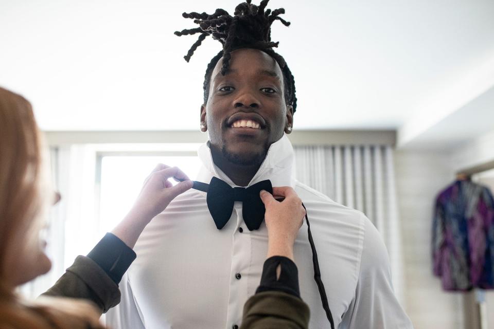 Jessie Johnson, Equity Sports' head of media and public relations helps putting on a bowtie for Missouri defensive lineman Darius Robinson as he prepares for the red carpet event before the NFL draft in Detroit on Thursday, April 25, 2024.