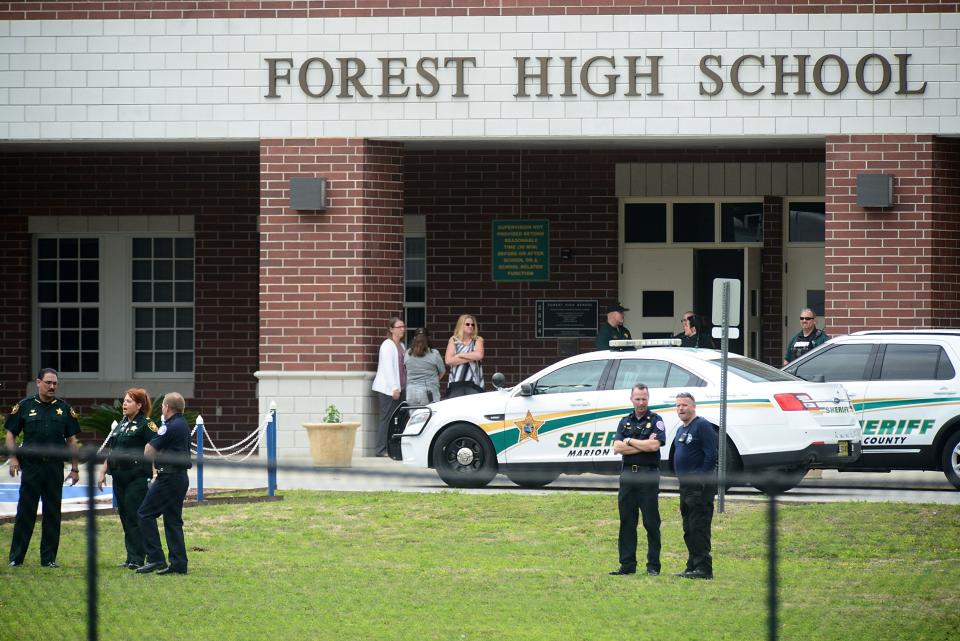 Marion County police officers stand in front of Forest High School after a school shooting on April 20, 2018, in Ocala, Fla. 