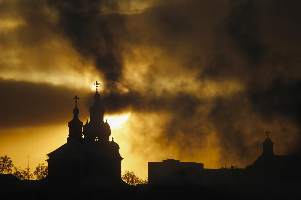 FILE - The sun rises above Orthodox Church, left, and Catholic Church in the town of Novogrudok, Belarus, about 150 kilometers (93 miles) west of the capital of Minsk, on Sunday, Jan. 17, 2016. Dozens of clergymen in Belarus — Catholic, Orthodox and Protestant alike — have been jailed, silenced or forced into exile for supporting protests of the 2020 election that gave authoritarian President Alexander Lukashenko a sixth term. (AP Photo, File)