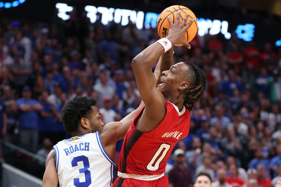 North Carolina State Wolfpack guard DJ Horne (0) controls the ball against Duke Blue Devils guard Jeremy Roach (3) in the second half in the finals of the South Regional of the 2024 NCAA Tournament at American Airline Center.