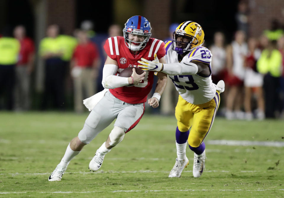 Shea Patterson (L) attempts to fight off LSU linebacker Corey Thompson in the first half of an NCAA college football game in Oxford, Miss., Saturday, Oct. 21, 2017. No. 24 LSU won 40-24. (AP Photo/Rogelio V. Solis)