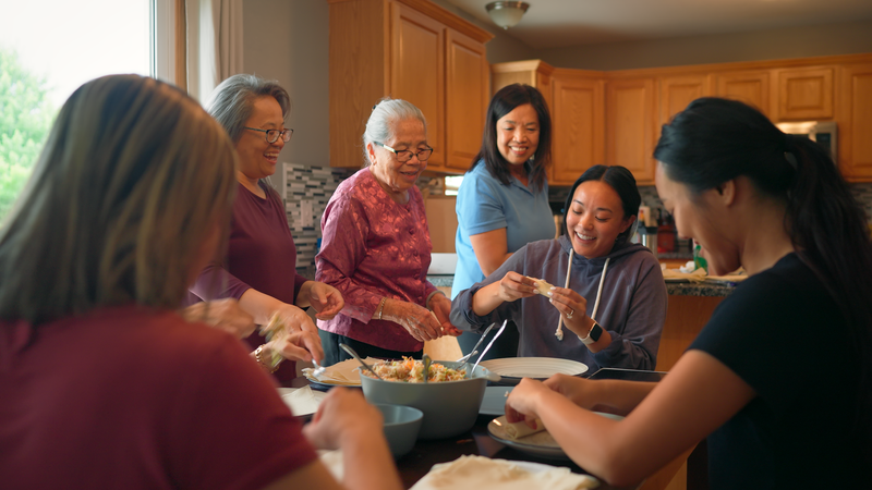 Jasmine Newland, center, cooks traditional Tai Dam cuisine with her family in a scene from "Refugees Welcome," a documentary about the Tai Dam community's arrival in Iowa. The documentary premiered May 8, 2024 on the Very Local streaming platform.