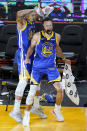 Golden State Warriors forward Juan Toscano-Anderson, left, pours water onto guard Stephen Curry (30) after the Warriors defeated the Denver Nuggets in an NBA basketball game in San Francisco, Monday, April 12, 2021. (AP Photo/Jeff Chiu)