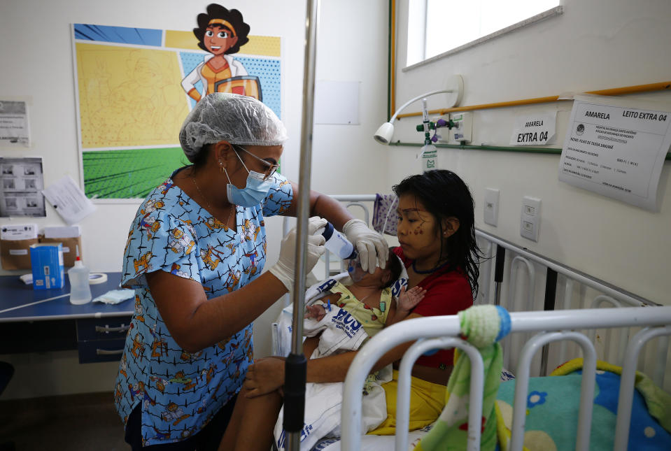 A Yanomami baby is fed by a nurse at the Santo Antonio Children's Hospital, in Boa Vista, Roraima state, Brazil, Thursday, Jan 26, 2023. Brazil's government declared a public health emergency for the Yanomami people in the Amazon, who are suffering from malnutrition and diseases such as malaria. (AP Photo/Edmar Barros)