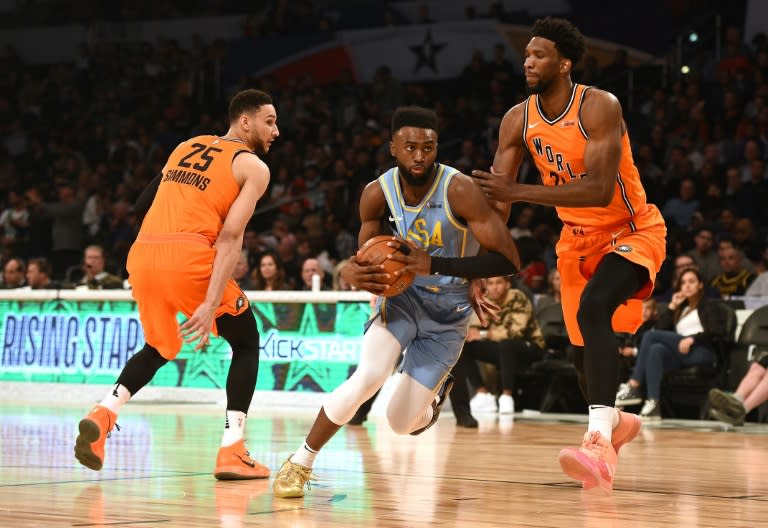 Jaylen Brown of Team USA drives to the basket against Joel Embiid (R) of Team World during the NBA 2018 All-Star Weekend