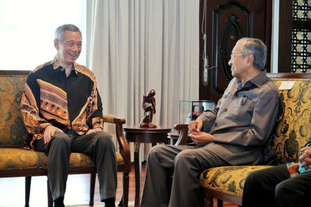 Malaysia's Prime Minister Mahathir Mohamad meets with Singapore's Prime Minister Lee Hsien Loong at the Perdana Leadership Foundation in Putrajaya, Malaysia on May 19, 2018 in this handout photo. Singapore's Ministry of Communication and Information/Handout via REUTERS