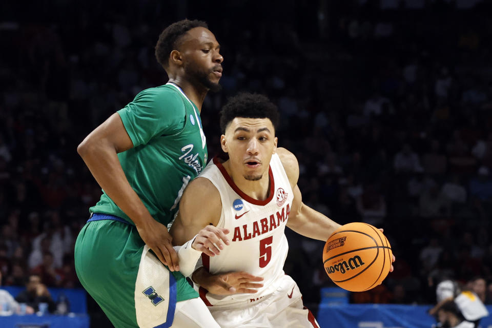 Alabama guard Jahvon Quinerly (5) dribbles around Texas A&M-CC forward Isaac Mushila (10) in the first half of a first-round college basketball game in the NCAA Tournament in Birmingham, Ala., Thursday, March 16, 2023. (AP Photo/Butch Dill)