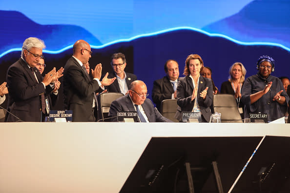 COP27 President and Egyptian Foreign Minister Sameh Shoukry speaks as fellow delegates clap during the closing session of the climate summit. (Anadolu Agency / Anadolu Agency via Getty Images)