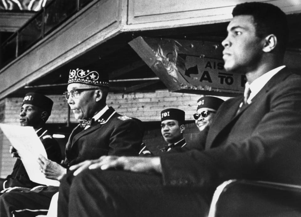 <div class="inline-image__title">517481124</div> <div class="inline-image__caption"><p>"Heavyweight boxing champion Muhammad Ali (R) sits on the podium with Nation of Islam leader <span class="caas-xray-inline-tooltip"><span class="caas-xray-inline caas-xray-entity caas-xray-pill rapid-nonanchor-lt" data-entity-id="Elijah_Muhammad" data-ylk="cid:Elijah_Muhammad;pos:3;elmt:wiki;sec:pill-inline-entity;elm:pill-inline-text;itc:1;cat:ReligiousFigure;" tabindex="0" aria-haspopup="dialog"><a href="https://search.yahoo.com/search?p=Elijah%20Muhammad" data-i13n="cid:Elijah_Muhammad;pos:3;elmt:wiki;sec:pill-inline-entity;elm:pill-inline-text;itc:1;cat:ReligiousFigure;" tabindex="-1" data-ylk="slk:Elijah Muhammad;cid:Elijah_Muhammad;pos:3;elmt:wiki;sec:pill-inline-entity;elm:pill-inline-text;itc:1;cat:ReligiousFigure;" class="link ">Elijah Muhammad</a></span></span> while attending the National Meeting of the Black Muslims. Ali drew a standing ovation when he addressed the crowd at the International Amphitheater in Chicago."</p></div> <div class="inline-image__credit">Bettmann</div>