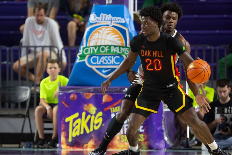 Oak Hill Academy's Chris Livingston (20) dribbles against IMG Academy's Jarace Walker (25) during the second half of the 48th annual City of Palms Classic semifinal between IMG Academy and Oak Hill Academy, Tuesday, Dec. 21, 2021, at Suncoast Credit Union Arena in Fort Myers, Fla.Oak Hill Academy defeated IMG Academy 76-72.