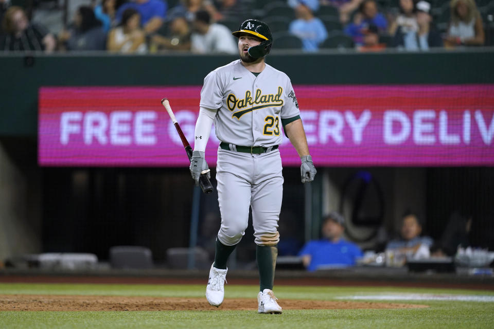 Oakland Athletics' Shea Langeliers walks back to the dugout after striking out during the seventh inning of the team's baseball game against the Texas Rangers in Arlington, Texas, Tuesday, Aug. 16, 2022. (AP Photo/Tony Gutierrez)