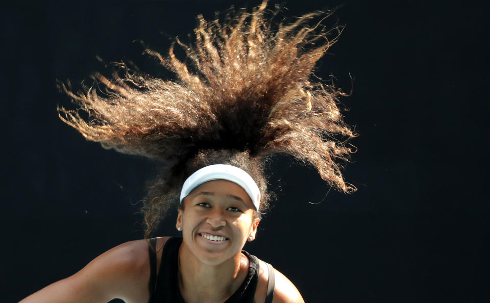 FILE - In this Jan. 18, 2020, file photo, Japan's Naomi Osaka serves during a practice session ahead of the Australian Open tennis tournament in Melbourne, Australia. Osaka has been selected by The Associated Press as the Female Athlete of the Year. (AP Photo/Lee Jin-man, File)
