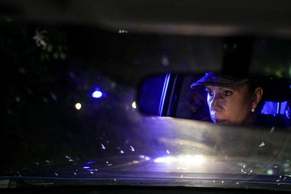 Police officer Georgina Wilke drives her patrol car in Rosario, Argentina, late Monday, April 8, 2024. Agents fanned out across hardscrabble areas, spending hours logging neighborhood activity and setting up checkpoints on major thoroughfares. (AP Photo/Natacha Pisarenko)