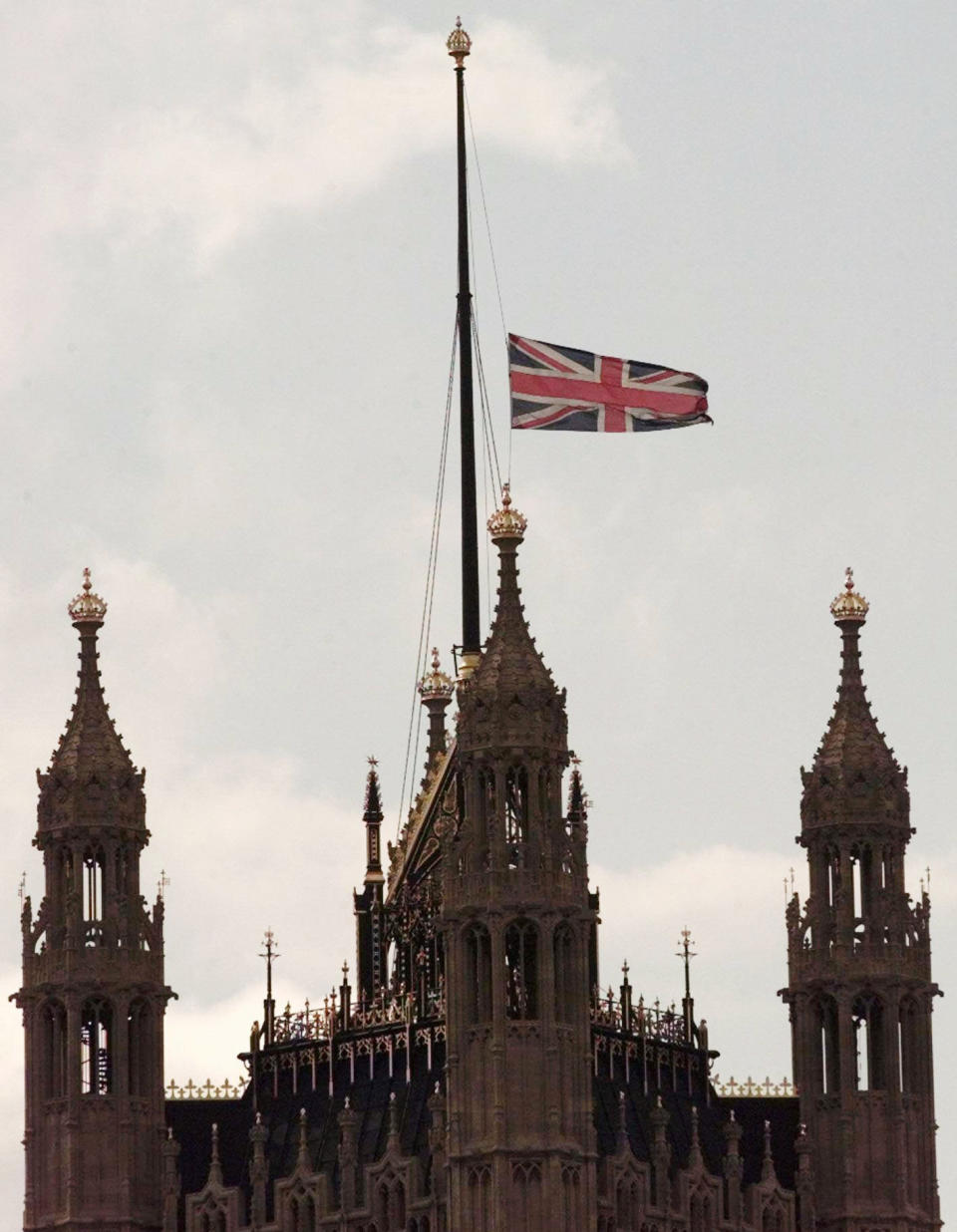 FILE - The Union Flag flies at half-mast over the Houses of Parliament in London, Aug. 31, 1997, following the death of Diana, Princess of Wales. Diana along with her companion, Dodi Fayed, and the driver of their car were killed in a car crash early Sunday in Paris. The story of Princess Diana's death at age 36 in that catastrophic crash in a Paris traffic tunnel continues to shock, even a quarter-century later. (AP Photo/Lynne Sladky, File)