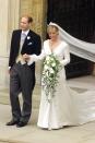 <p>The Countess of Wessex married the Queen's youngest son, Prince Edward, in a sleek ivory silk organza gown by Sophie Shaw, which she layered with a matching silk coat. </p>