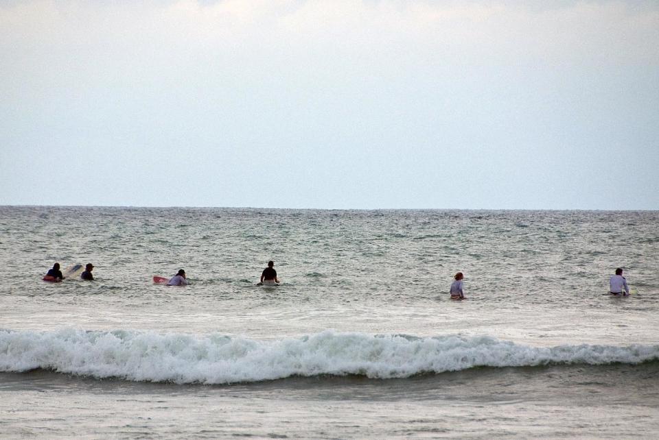 This 2010 photo shows people waiting for a wave while surfing in Malpais, Costa Rica, at the Pura Vida Adventures camp. The camp is an example of active vacations tailored to travelers who value healthy lifestyles and new experiences. (AP Photo/Perry Horwich)