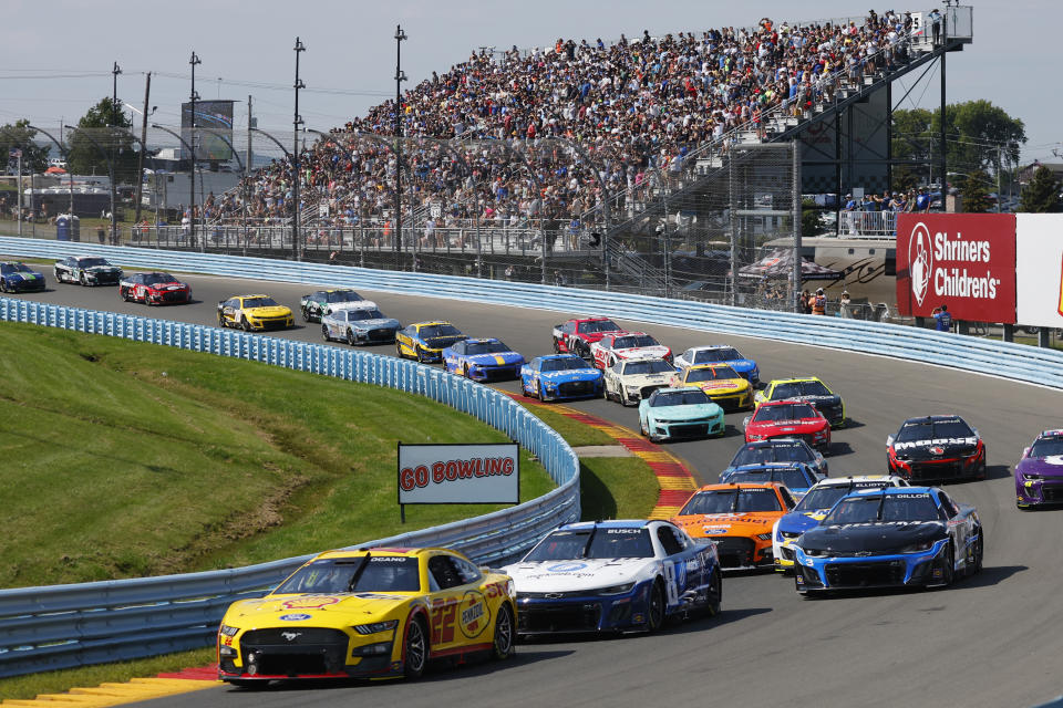 Joey Logano leads a pack of cars entering Turn 2 during a NASCAR Cup Series auto race in Watkins Glen, N.Y., Sunday, Aug. 20, 2023. (AP Photo/Jeffrey T. Barnes)
